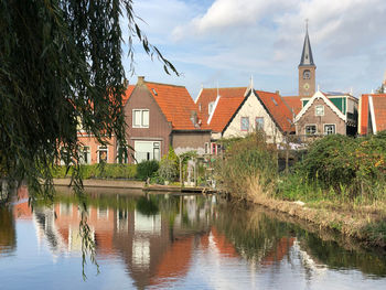 Reflection of trees and buildings in lake