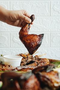 Close-up of hand holding chicken