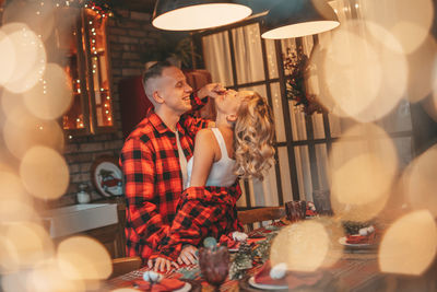 Candid authentic happy married couple spends time alone at lodge xmas decorated