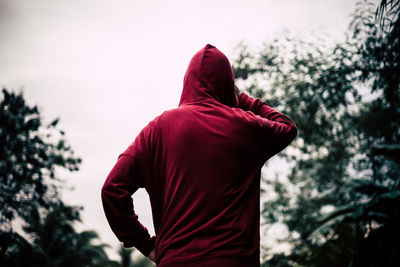 Rear view of man standing against sky