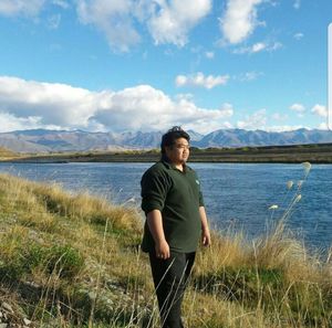 Full length of man standing on lake against sky