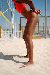 Woman with afro hair playing beach volleyball