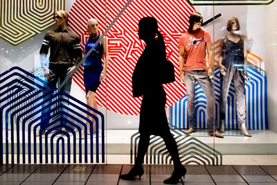 Women walking in corridor of flags