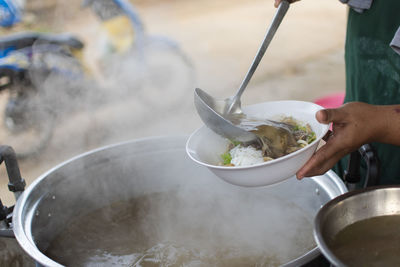 Midsection of person preparing food in kitchen