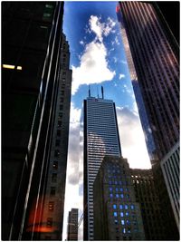 Low angle view of modern building against cloudy sky