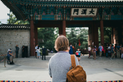 Rear view of women walking in building