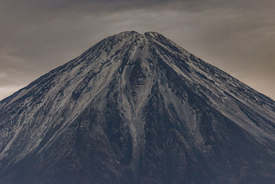 Low angle view of snowcapped mountain against sky