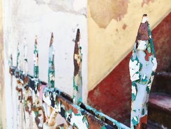 Close-up of rusty metallic fence against building