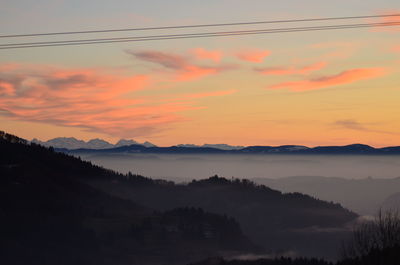 Scenic view of silhouette mountains against sky during sunset