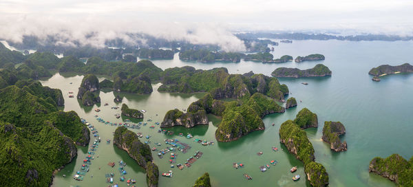 High angle view of townscape by sea against sky