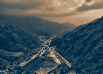 Aerial view of snowcapped mountains against sky