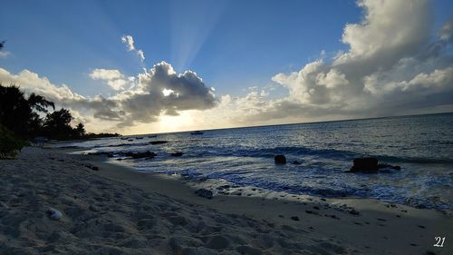 Scenic view of beach against sky during sunset