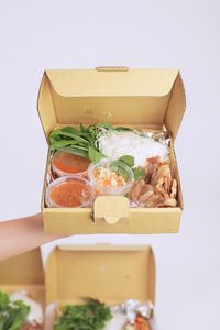 Close-up of food in box against white background