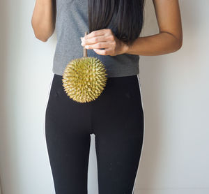 Asian slim woman holding durian, king of fruit in thailand, delicious.