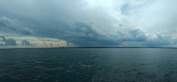 Scenic view of sea against storm clouds