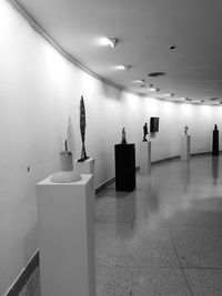 Low angle view of illuminated lighting equipment on ceiling