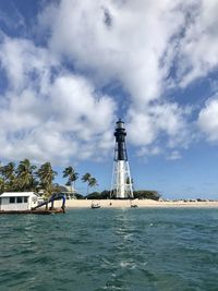 Lighthouse on the beach, big sky, boatin