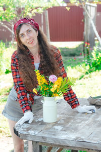 Portrait of a smiling farmer girl with a bouquet of flowers on the street