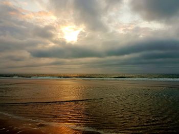 Scenic view of beach against sky during sunset