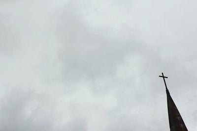 Low angle view of building against cloudy sky