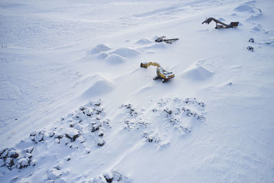 Mountainous area with excavators in winter
