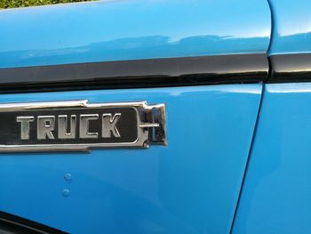 Cropped image of text on blue semi-truck