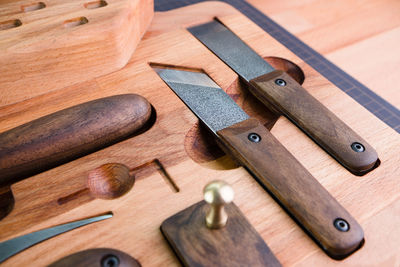 High angle view of work tools on wooden table