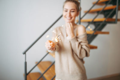 Portrait of a smiling young woman holding umbrella