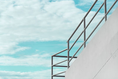 Low angle view of staircase by building against sky