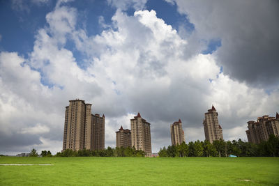 Panoramic view of buildings against cloudy sky