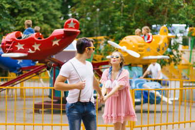 Cheerful couple walking in an amusement park