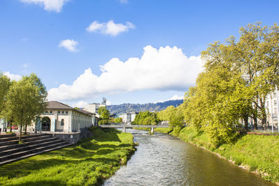 River amidst buildings against sky