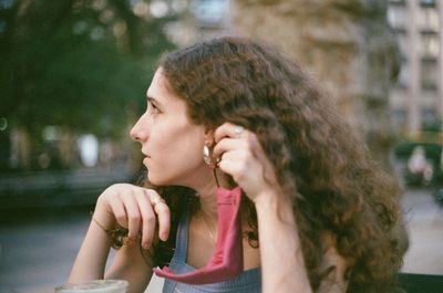 Portrait of smiling young woman looking away outdoors