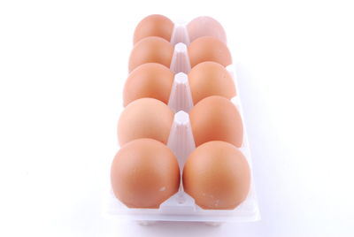 Close-up of eggs against white background