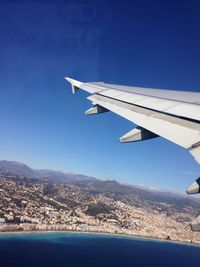 Cropped image of airplane flying over landscape