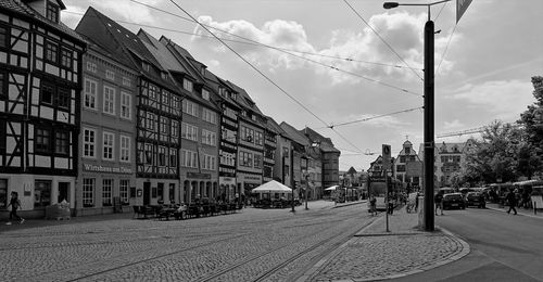 City street by buildings against sky