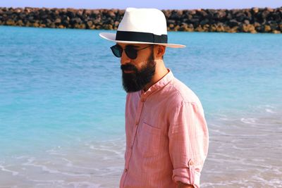 Young man standing in sea