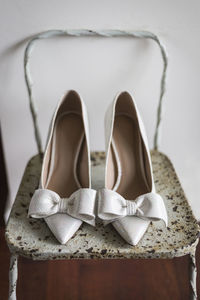 Close-up of shoes on rusty chair