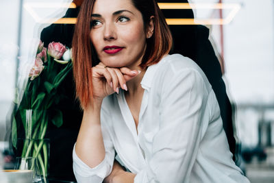 Close-up of thoughtful woman sitting at restaurant