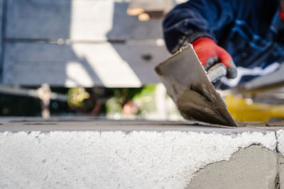 Low section of man working on concrete in city