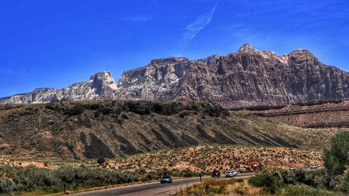 Scenic view of mountains against blue sky