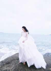 Young woman standing at beach