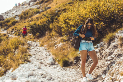 Full length portrait of woman standing outdoors