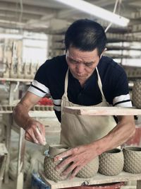 Mid adult man working in container