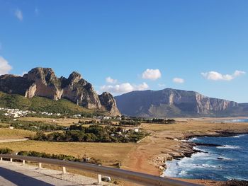 Scenic view of mountains against blue sky