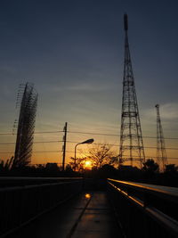 Silhouette of communications tower at sunset