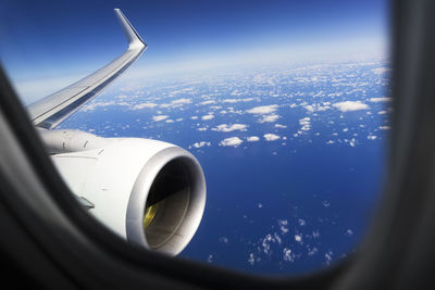 Airplane flying in sky seen through window