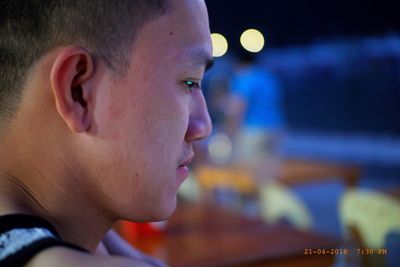 Close-up portrait of young man looking away