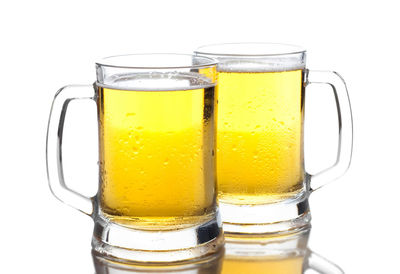 Close-up of beer glass against white background