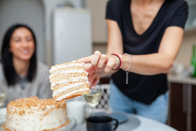 Midsection of woman holding ice cream